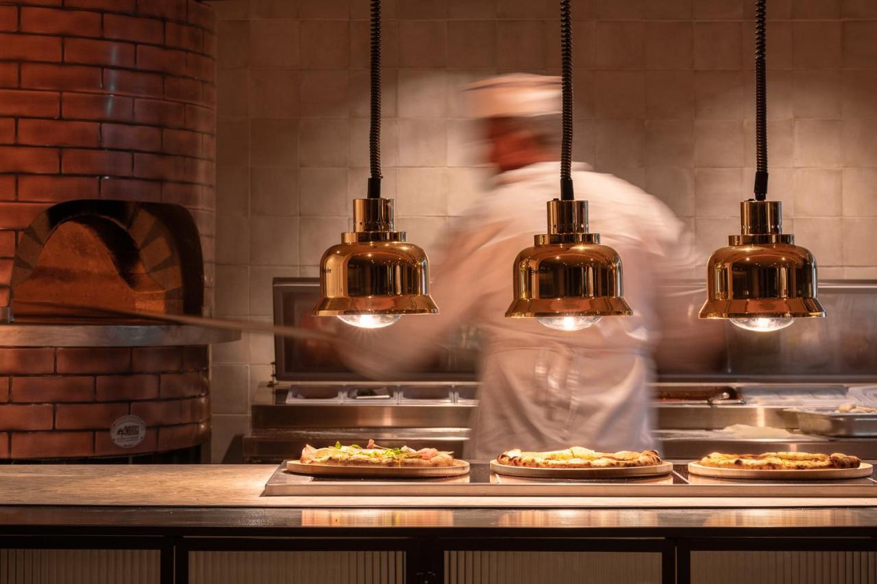 Helea Lifestyle Beach Resort Kallithéa Esterno foto Pizzas being prepared at a restaurant